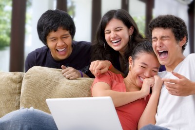 Older-teens-laughing-at-computer-screen.