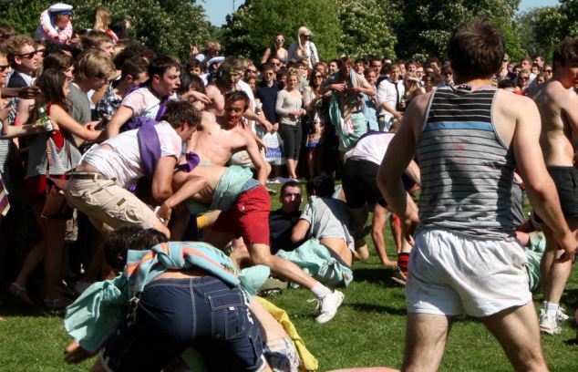 PIC BY GEOFF ROBINSON PHOTOGRAPHY 07976 880732.
******NO BYLINE********
PIC SHOWS  THE organised FIGHT between the Caesarians, Jesus' inter-year drinking society and the Girton Green Giants,on Jesus Green Cambridge during Caesarian Sunday drinking party.
 Passers-by were shocked to see more than 1000 drunken Cambridge University students STRIPPING OFF and VOMITING at a riotous summer term party in a PUBLIC park in the historic city centre.
Families enjoying the spring sunshine were disgusted to see rowdy students downing excessive amounts of alcohol, then THROWING UP and WEEING in the park flower beds at midday on a Sunday afternoon.
More than 1000 students attended yesterday's (May 1) annual party, known as Caesarian Sunday, which historically takes place on Jesus Green in Cambridge on the first bank holiday of the summer term.
Many of them were members of the college drinking societies and spent the day taking part in shocking and bizarre initiation ceremonies.
Girls were seen drinking port through condoms, while others wore kippers round their necks while they downed pints.
SEE COPY CATCHLINE Cam Uni students drunk party